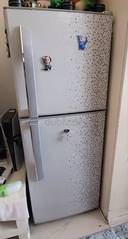 Silver double-door fridge/freezer in working condition