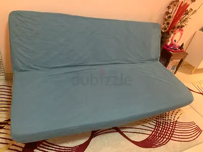Blue fold-out sofa bed — good condition, compact size