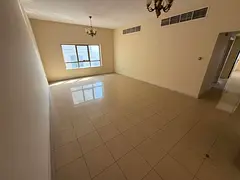 A direct view of Ajman Corniche, a two-bedroom apartment with a spacious living room and a balcony o