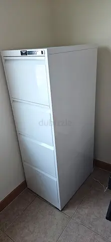 Tall white upright safe office closet