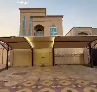 Commercial villa in Al Muwaihat, situated on a corner plot with two paved street frontages. Features 8 bedrooms, a spacious layout, and an excellent l