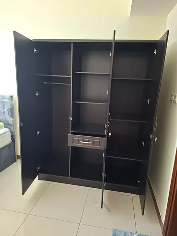 Large dark wood wardrobe/armoire with multiple compartments and hanging rail