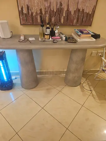 Concrete-style console table with rounded pedestal legs