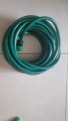 green garden hose, good condition (approx 20m)