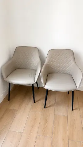Pair of modern padded dining chairs - beige faux leather