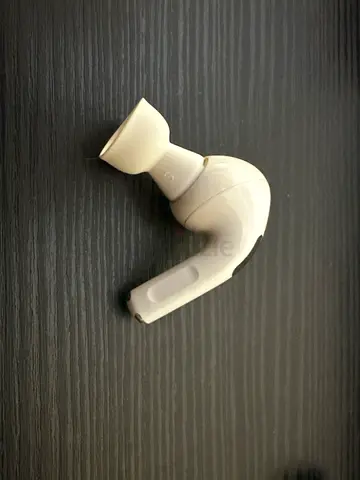 Single white wireless in-ear earbud - left side