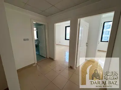 Two-bedroom apartment with a living room for annual rent in Al Majaz 3, including two bathrooms, central air conditioning, and built-in wardrobes.