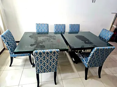 7-seater extendable dining table with glass top with 6 upholstered chairs