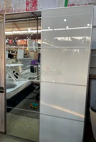 White sliding-door wardrobe with hanging rail and shelf (IKEA-style)