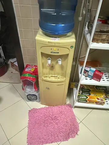 Used freestanding water dispenser with bottle