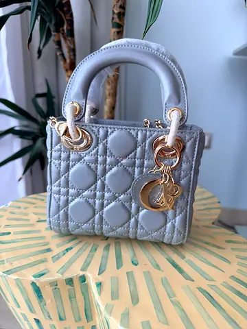 Small quilted baby blue handbag with gold hardware