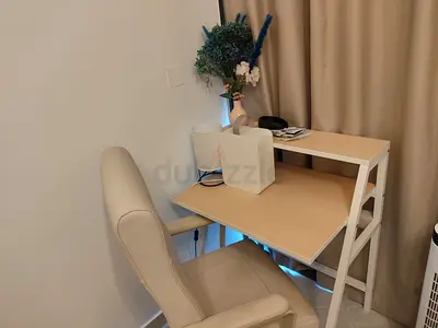 Compact ladder-style computer desk with beige faux leather office chair