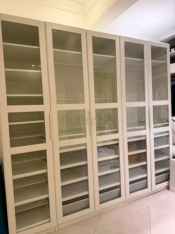 White sliding-door wardrobe with open shelving and drawers