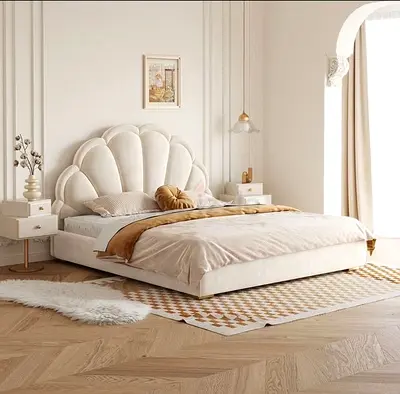 Low platform shell-headboard bed frame in cream upholstered fabric with mattress