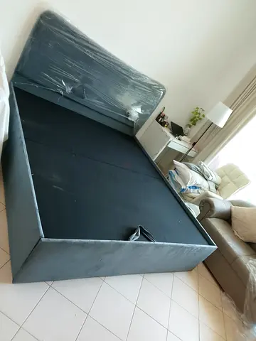 Grey upholstered double bed frame with headboard -