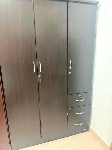 Dark wood 3-door wardrobe with drawers — good condition