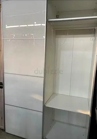 White sliding-door wardrobe with hanging rail and shelf (IKEA-style)