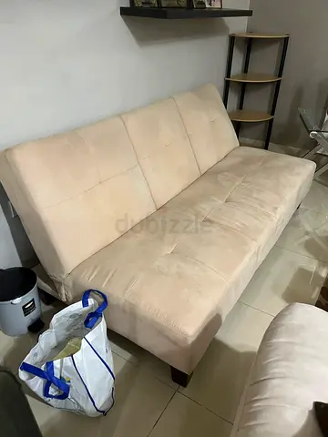 Beige three-seater fabric sofa bed — good condition