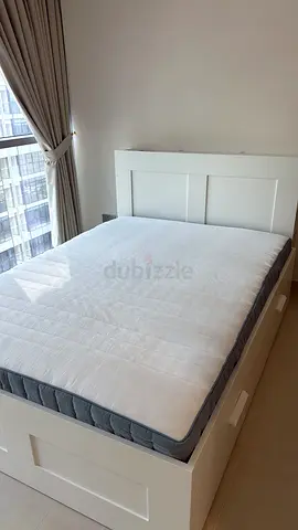 White wooden storage bed with headboard and mattress - good condition