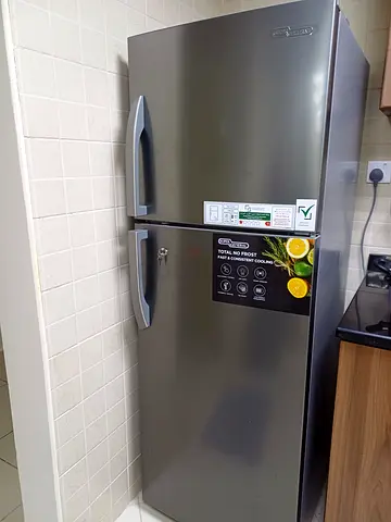 Used double-door refrigerator in good condition - stainless steel finish