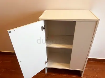 Compact white storage cabinet with single door - good condition