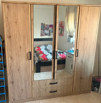 4-door wooden wardrobe with mirrored center and drawers - good condition