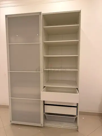 White sliding-door wardrobe with open shelving and drawers