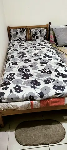 Ikea Single wooden bed frame with mattress and bedding