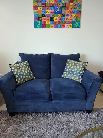 Two-seater navy blue fabric sofa in good condition