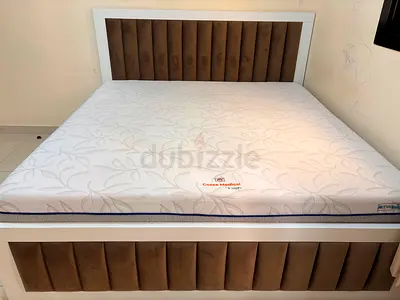 White wooden bed frame with padded headboard and mattress - king size with storage