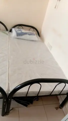 Single bed with mattress and cupboard