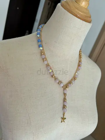 Delicate gold-tone beaded necklace with pastel stones and star charm