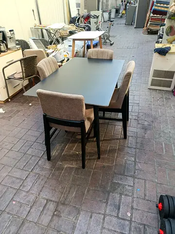 Solid black dining table with 4 upholstered chairs - good condition