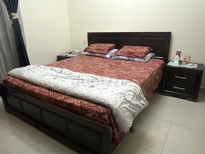 King size wooden bed with two matching bedside tables and 4 doors wardrobe