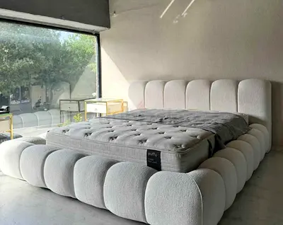 Modern plush upholstered king-size bed frame in light grey