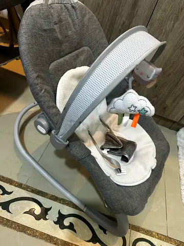Gently used grey baby rocker / bouncer with toy bar