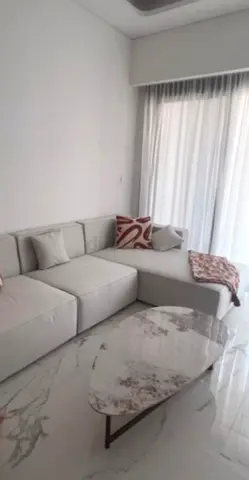 Light grey L-shaped sofa with cushions - good condition