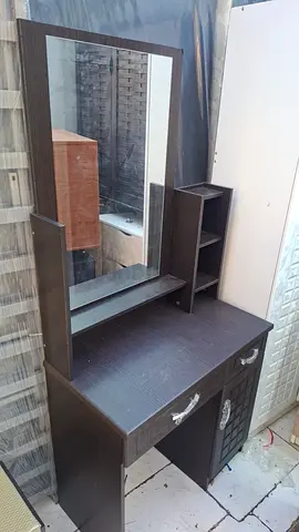 Dark wood dresser with large mirror and storage compartments