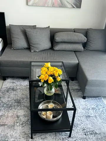 IKEA sofa bed with storage and glass coffee table