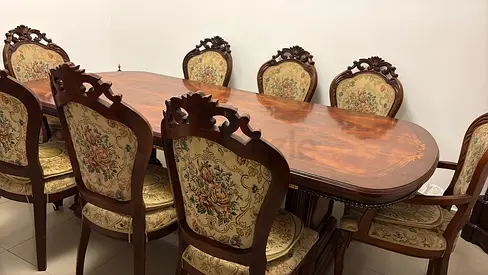 Antique-style solid wood 8-seater dining table with carved chairs