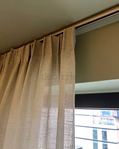 Light beige sheer curtains with roller blackout blind