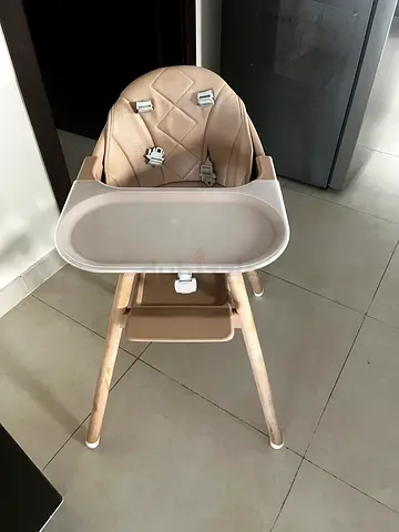 Beige wooden-frame baby high chair with tray - good condition