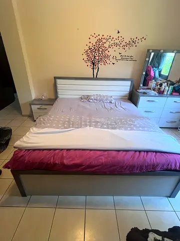 Queen bed frame with mattress and matching bedside table - excellent condition.