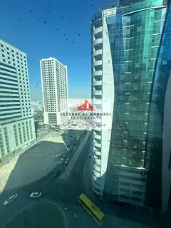 Two-bedroom apartment with a living room for sale in the Al Taawun area, Sharjah; features an open v