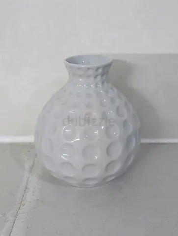 Small white ceramic decorative vase with textured dot pattern