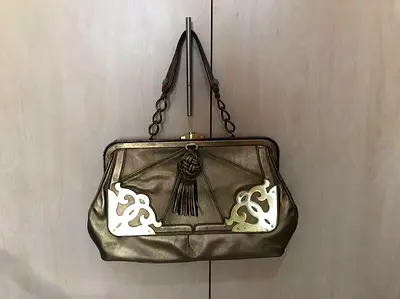 Bronze leather chain-handle shoulder bag with tassel and metal accents