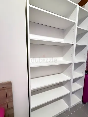White built-in wardrobe shelving unit with multiple compartments