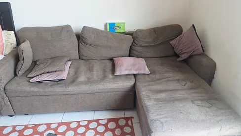 Used L-shaped gray fabric sofa with removable cushions