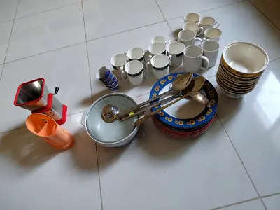 Mixed kitchenware set — plates, bowls, mugs, cutlery and kitchen tools (used)