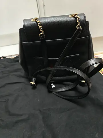 Black leather Chanel caviar backpack with gold chain straps - excellent condition.